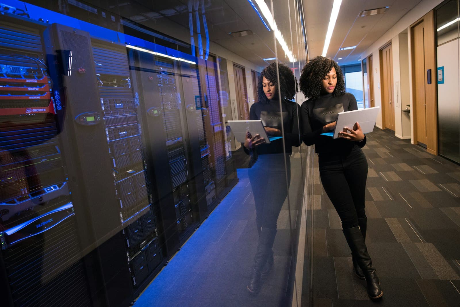 A corridor of server racks in a modern data centre