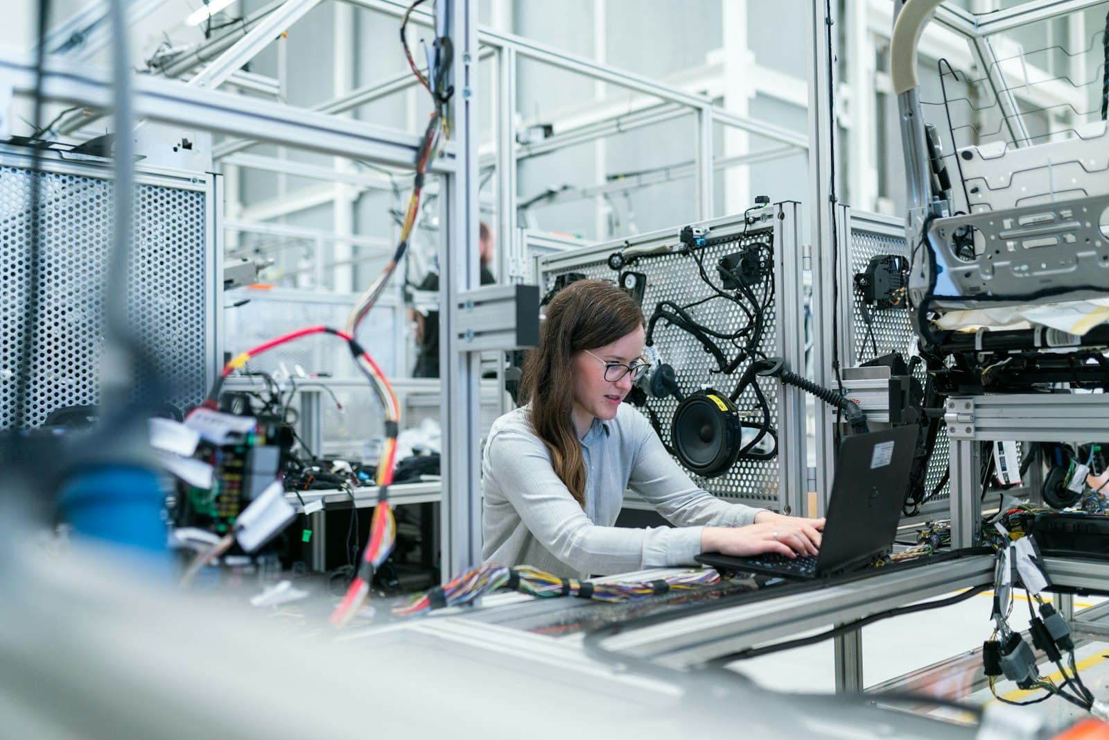 An engineer inspecting equipment on a manufacturing floor