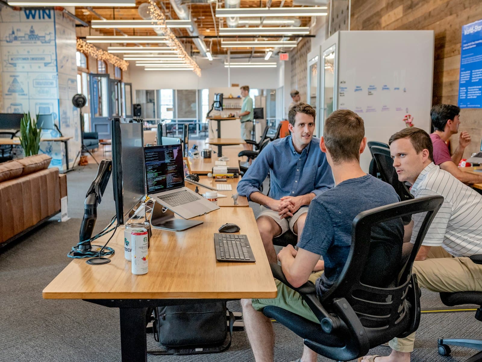 A bright open-plan office with teams working together